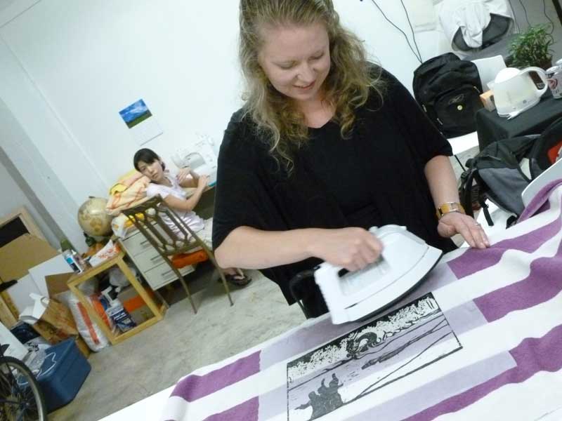 Click the image for a view of: Jessica ironing out the kinks That's artist/grad student Yoko Hattori in the back